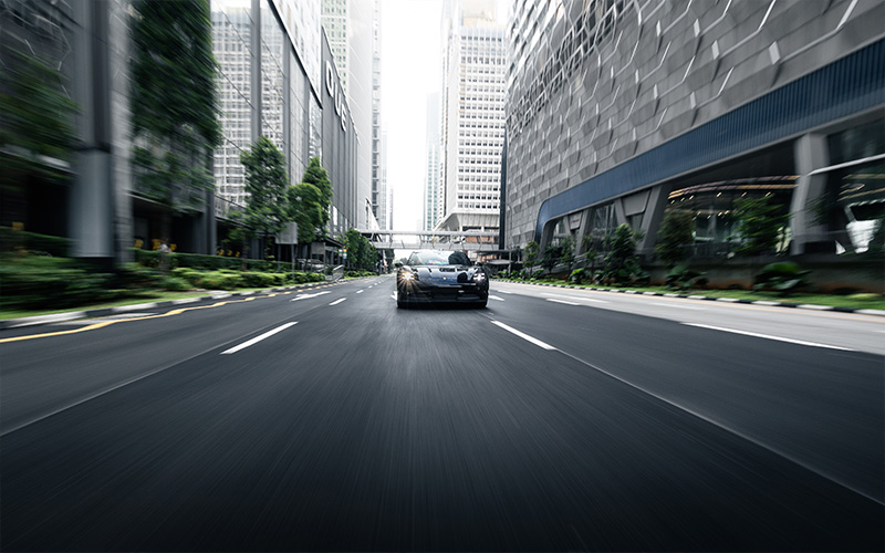 A black car driving smoothly in the highway